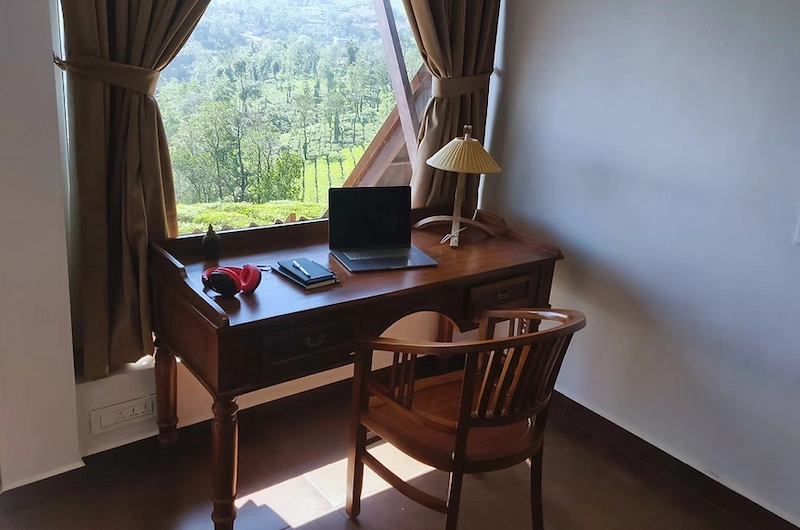 Spacious bedroom suite with workation desk setup at The Highlander resort in Vagamon Kerala