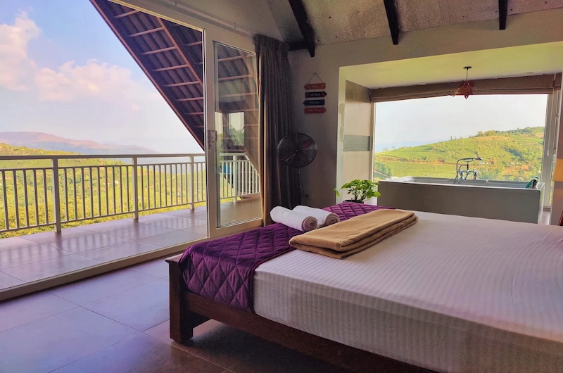 Bedroom suite opening to a private scenic balcony at The Highlander Vagamon