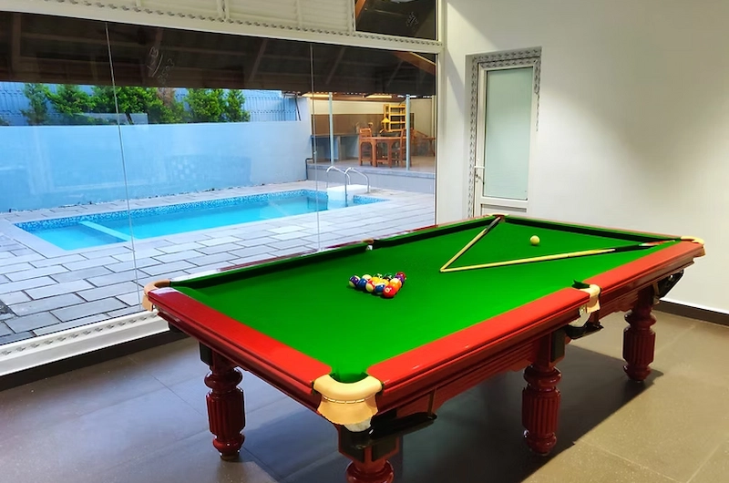 Indoor game room with billiards table at The Highlander resort in Vagamon Kerala