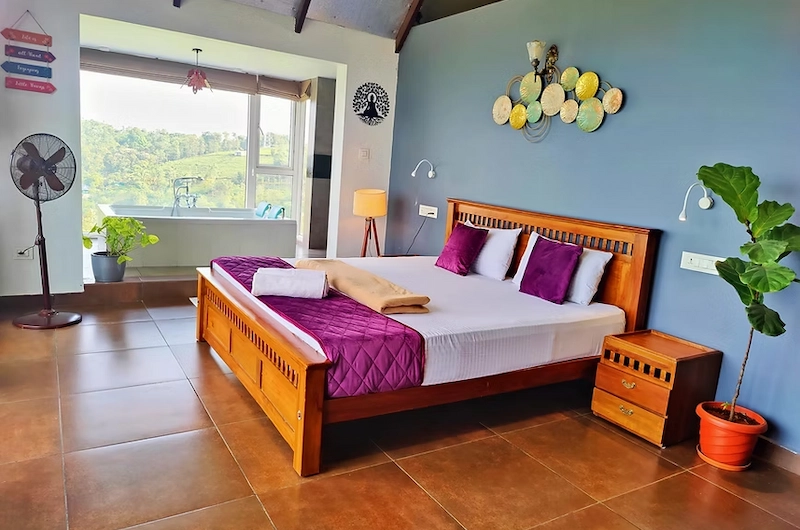 Spacious luxury bedroom with wooden floor and mountain views at The Highlander Vagamon