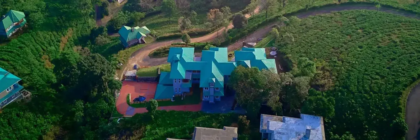 Aerial panoramic view of Priyas Villa Vagamon surrounded by tea plantations