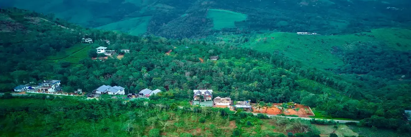 Stunning misty mountain valley view surrounding a premium luxury Choice Holidays Resort in Vagamon, Kerala.