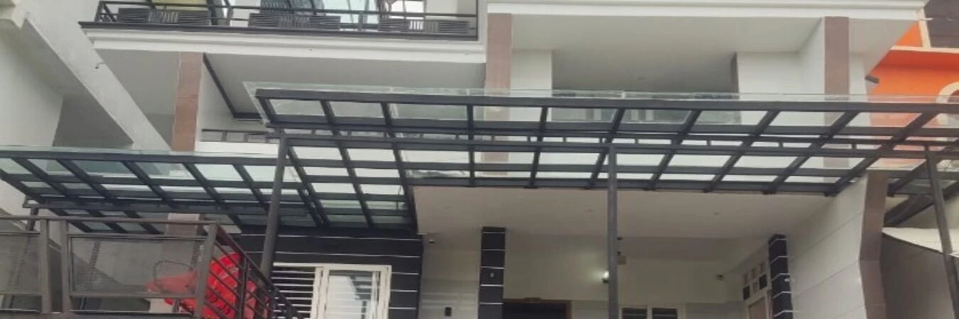 Modern exterior balcony area with glass canopy at Rock Lake Villa Vagamon