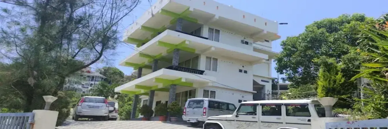 Exterior view of Vaga View Residency multi-story building during daytime in Vagamon