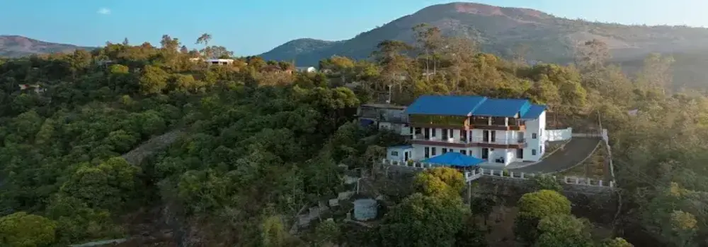 Aerial view of Moon Palace Kuttikanam homestay nestled on a green hilltop