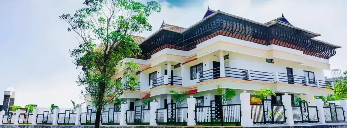 Exterior view of Vagamon Vagashore resort surrounded by lush greenery in Vagamon