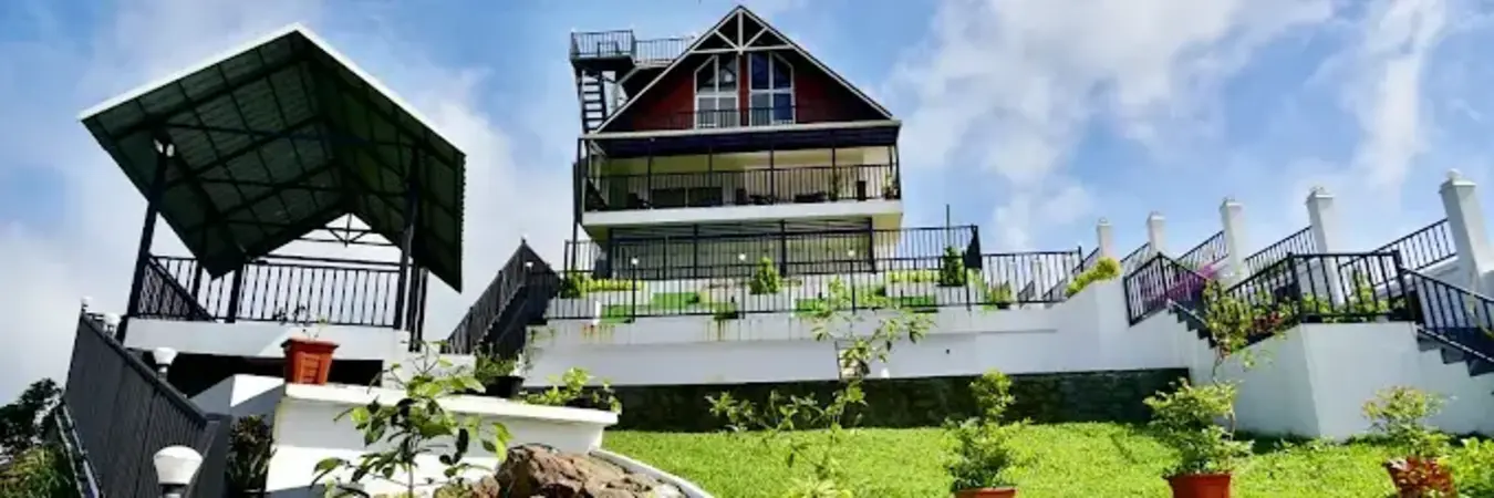 Landscaped green lawn and outdoor courtyard area with purple swing at ODMOR Resort Vagamon