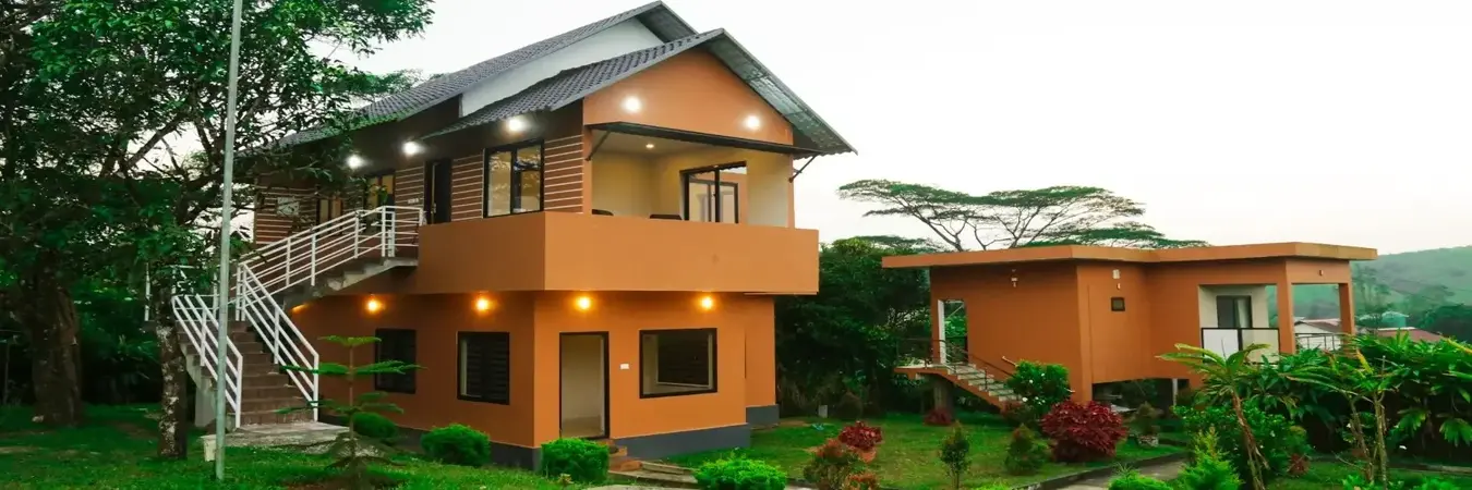 Terracotta resort cottage architecture with outdoor staircase at Cee Cee Grand Resort Vagamon