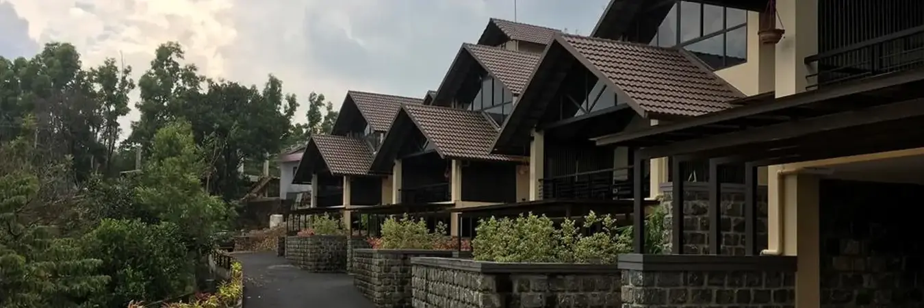 Luxury cottage exterior architecture and stone paved courtyard at Beyond Pines Vagamon