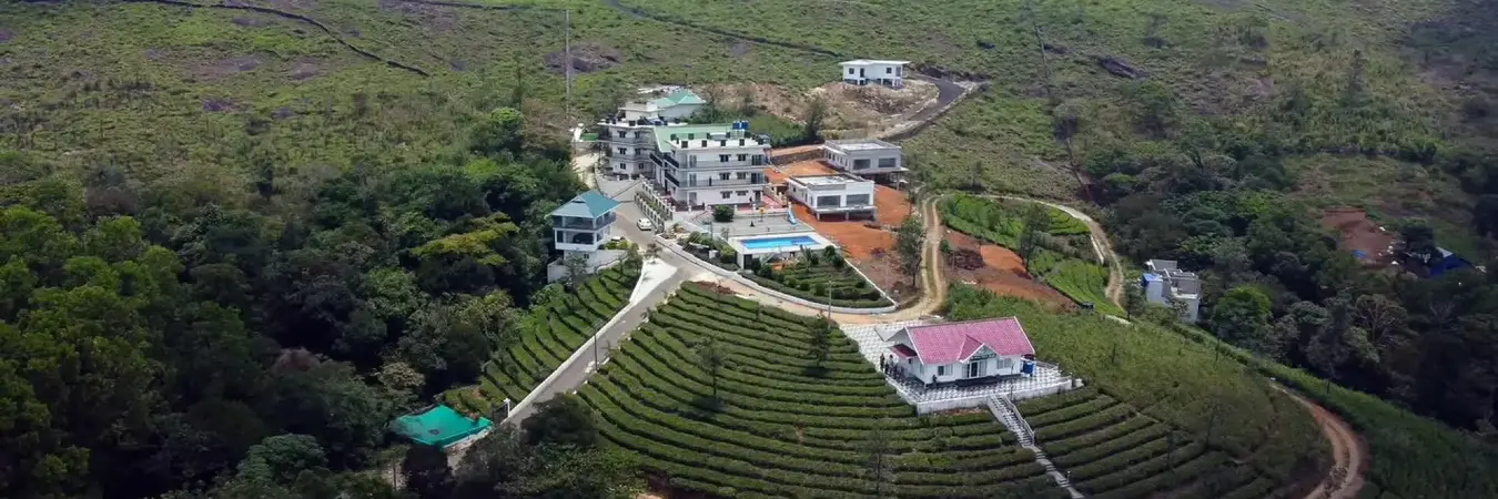 Aerial view of Pine Clough Resort surrounded by tea plantations in Vagamon