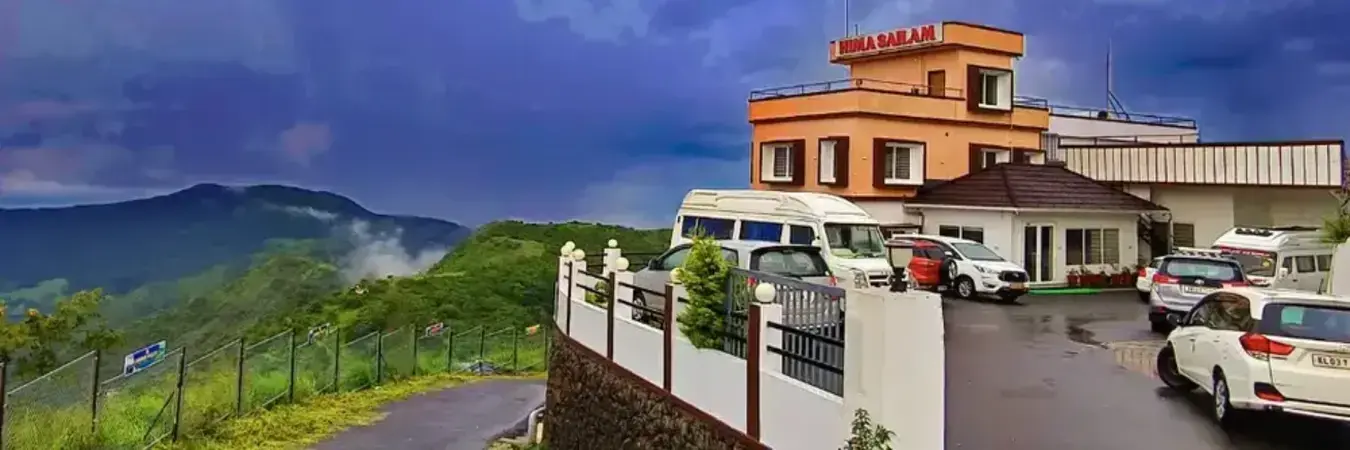 Panoramic exterior view of Himasailam Resort perched on foggy Thangalpara hills in Vagamon