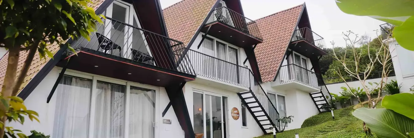 Luxury cottage resort rooms with large glass windows at Trip Mount Vagamon