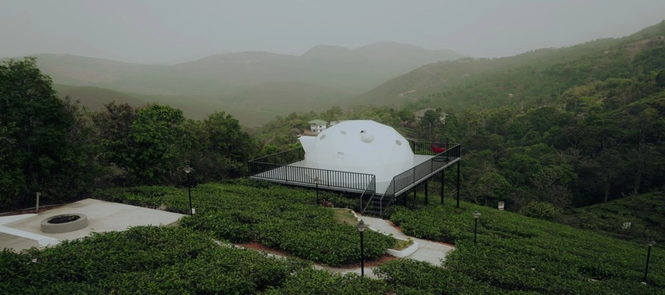 White geodesic dome glamp on a green hilltop at Pendora Glamps Vagamon