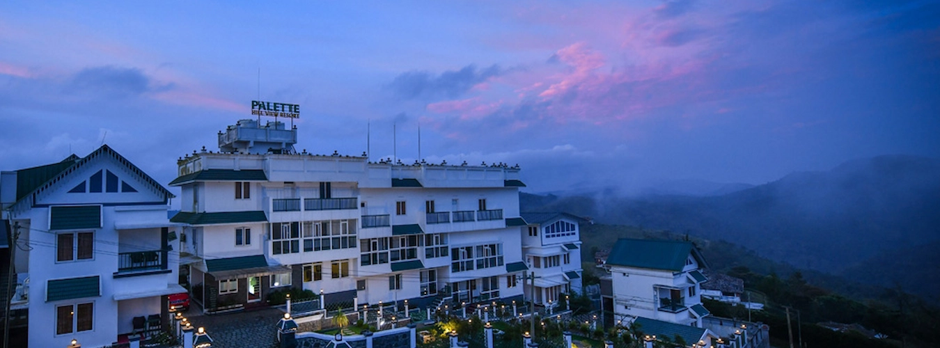 Aerial view of Palette Hill View Resort nestled in misty green Vagamon hills