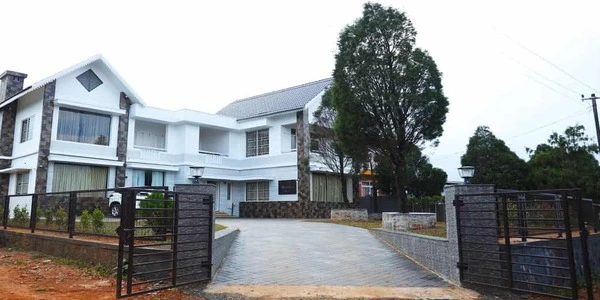 Front entrance and gated driveway of Mountain Mist Resort Vagamon Kerala