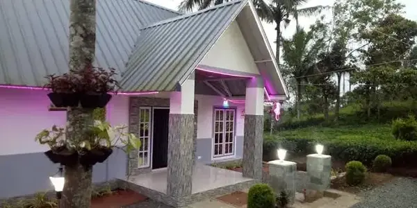 Modern villa cottage exterior with paved garden path at dusk at Eagle Rock Holiday Villas Peerumade