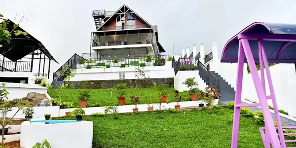 Green lawn and garden courtyard at ODMOR Resort Vagamon