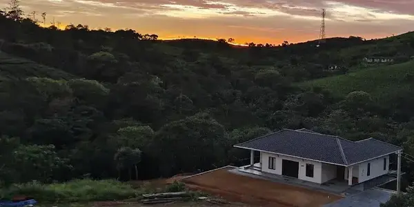 Aerial hill view of 8.5 Acres resort stay in Vagamon during golden hour sunset