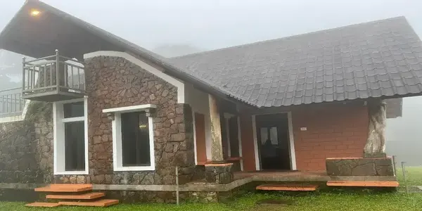 Exterior view of modern stone cottage rooms at Vagamon Heights in misty Vagamon hills