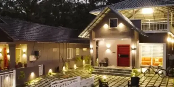Front entrance of Willow House Cottages illuminated at night with warm outdoor lighting