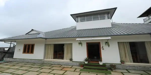 Exterior front elevation view of Vagamon Hill Chimes resort against scenic Vagamon hills