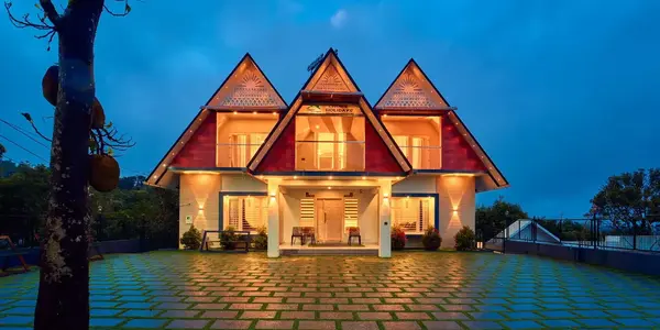 Exterior nighttime view of illuminated luxury villas at Choice Holidays Resort Vagamon by Voye Homes.