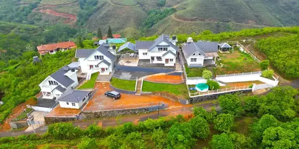 Aerial view of Nexstay Mount Tales resort set among green mountains in Vagamon Kerala