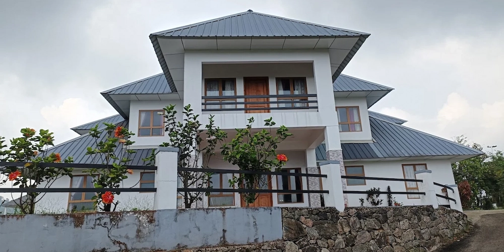 Exterior view of Zen Garden Wellness Homestay estate bungalow overlooking hills in Vagamon Kerala