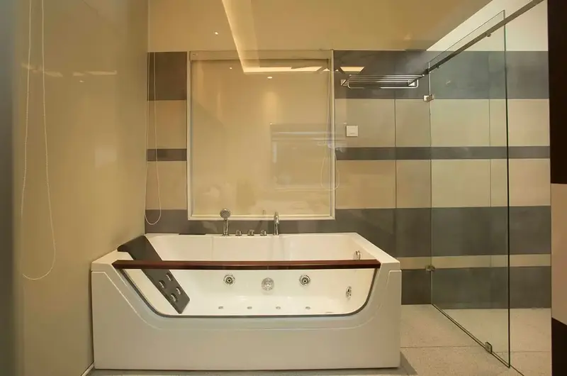 Spacious luxury guest bathroom featuring a private indoor Jacuzzi tub and modern glass partitions at Foggy Knolls Resort Vagamon