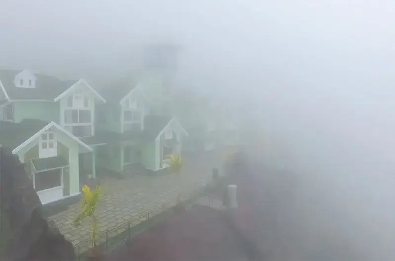 Scenic misty mountain landscape surrounded by fog and green nature at Foggy Knolls Resort Vagamon