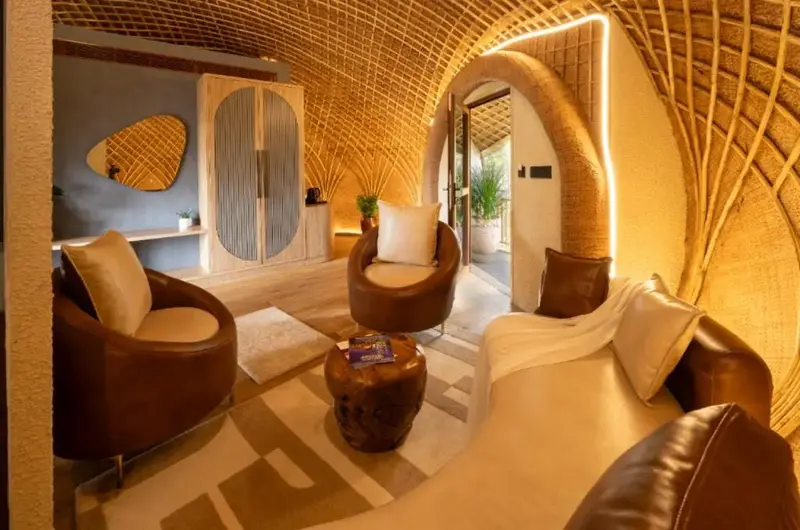 Spacious luxury dome interior with warm ambient lighting, elegant seating area, and contemporary decor at Monticle Glamps