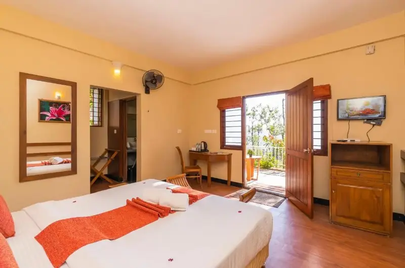 Cozy cottage bedroom interior with modern amenities at Winter Vale Green Stay Vagamon