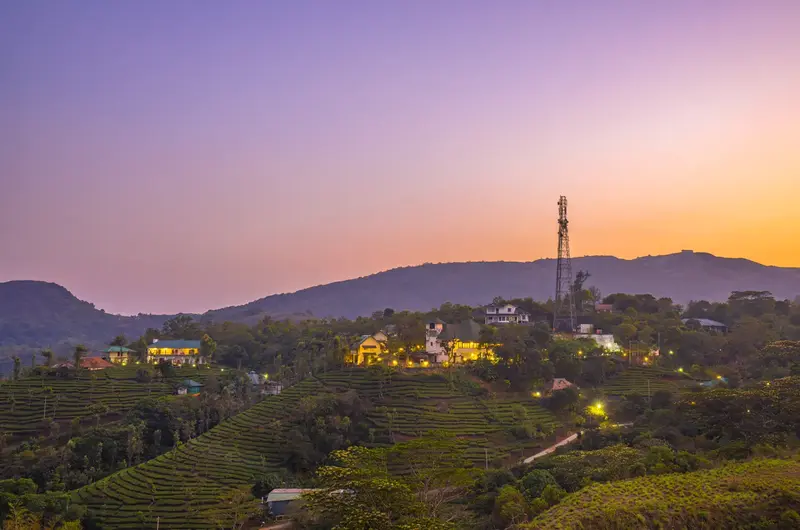 Sunset view over green misty mountain hills at Winter Vale Green Stay Vagamon
