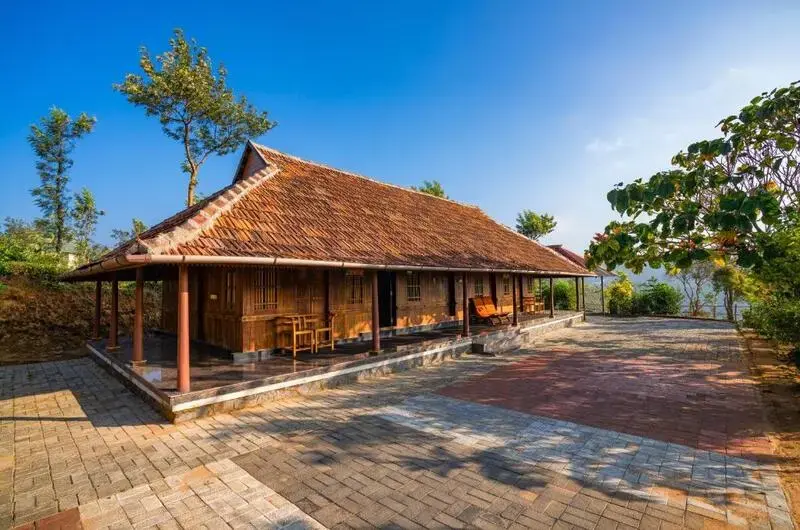 Traditional style Kerala cottage with garden walkway at Winter Vale Green Stay Vagamon