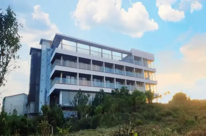 Modern multi-story hotel building facade of Palette Hill View Resort under clear blue skies