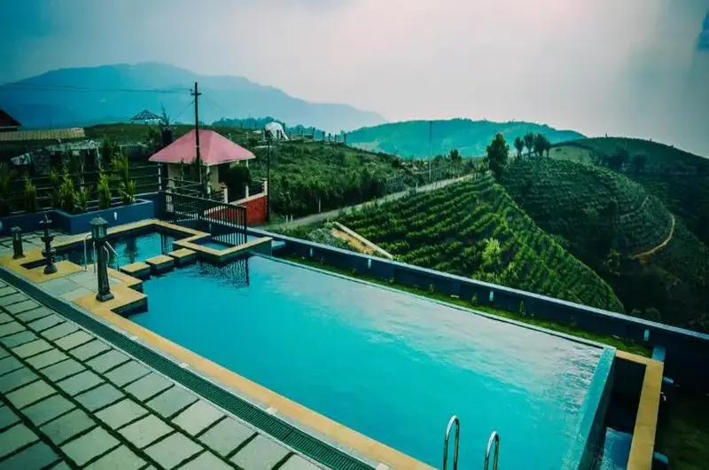 Outdoor infinity swimming pool with mountain view deck at Palette Hill View Resort Vagamon