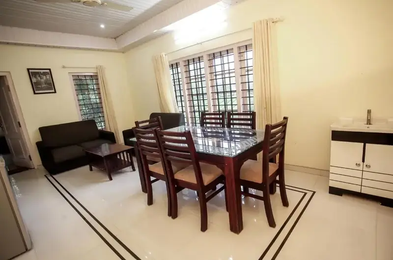 Cozy indoor dining area with wooden table and chairs inside Lavender Plantation Stay Vagamon