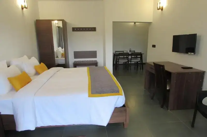 Modern family bedroom suite with plush double beds, dark wood accents, and warm lighting at Falcon Crest Resort
