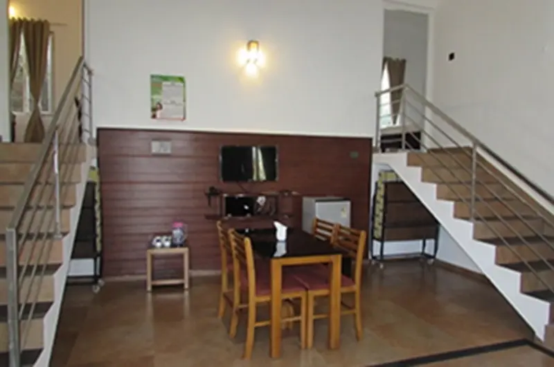 Spacious indoor dining area and wooden staircase leading to mezzanine loft at Falcon Crest Resort