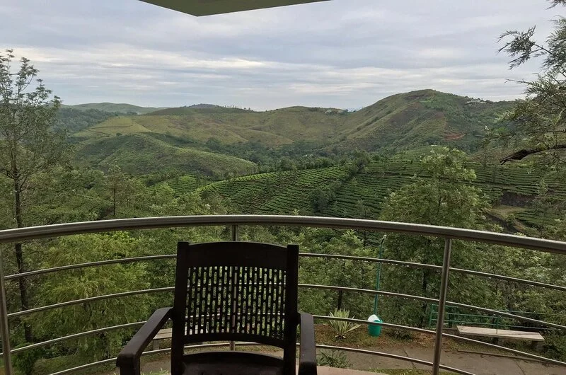 Private room balcony seating overlooking panoramic green mountain valleys at Falcon Crest Resort