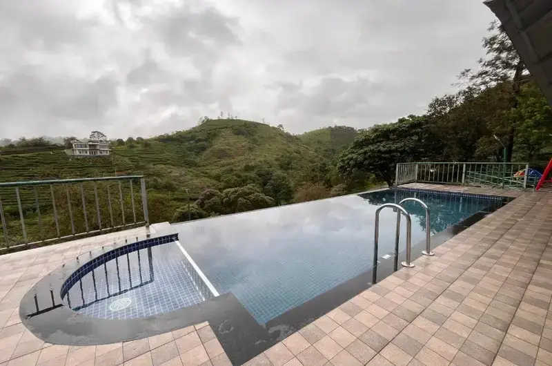 Outdoor swimming pool with scenic mountain deck view at Falcon Crest Resort Vagamon