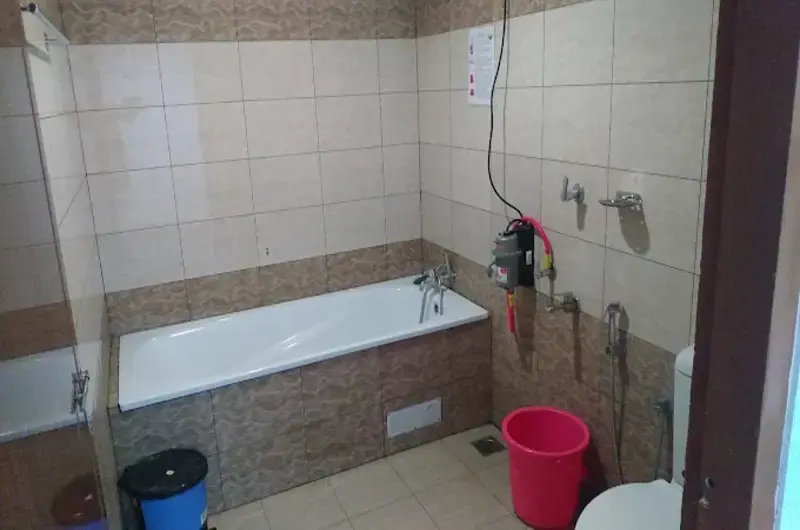 Clean attached modern bathroom with tiled walls and shower facilities at Vagamon Bamboo Nest Resort