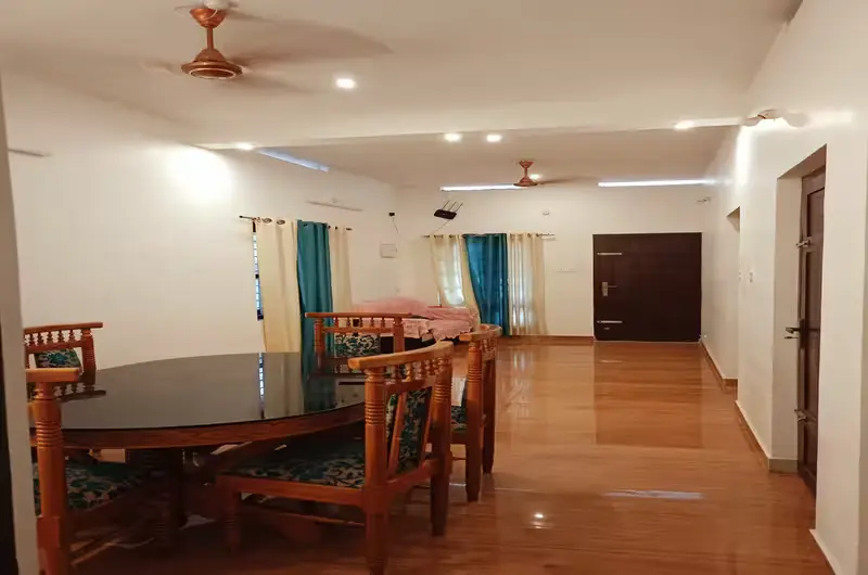 Spacious guest suite interior with comfortable seating and dining table at Wood Castle Residency