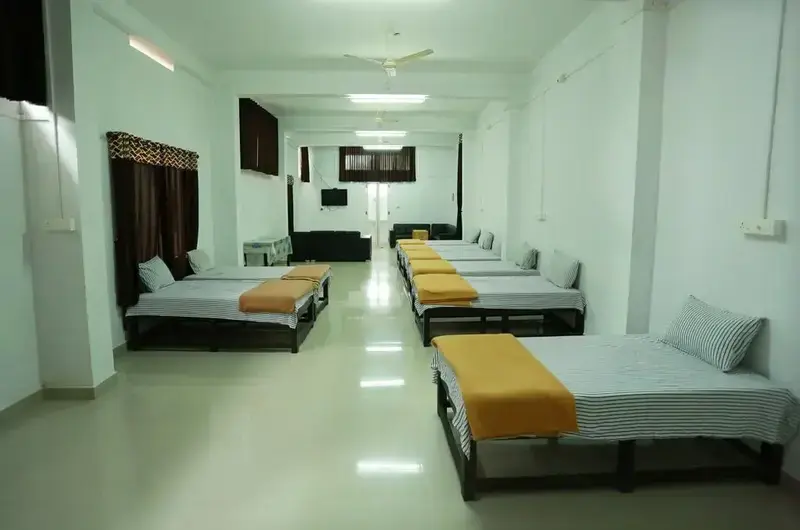 Spacious family room suite featuring multiple comfortable double beds with warm lighting at Chillax Hotel