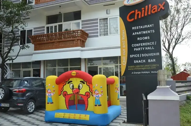 Hotel entrance with Chillax sign board and colorful inflatable play castle for children