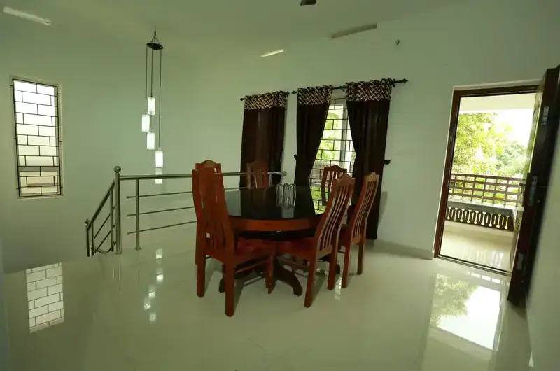 Modern guest suite interior featuring a spiral staircase, large windows, and bright tiled floors