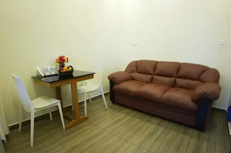Cozy indoor seating lounge with brown leather sofa and side table at Vaga Mist Resort