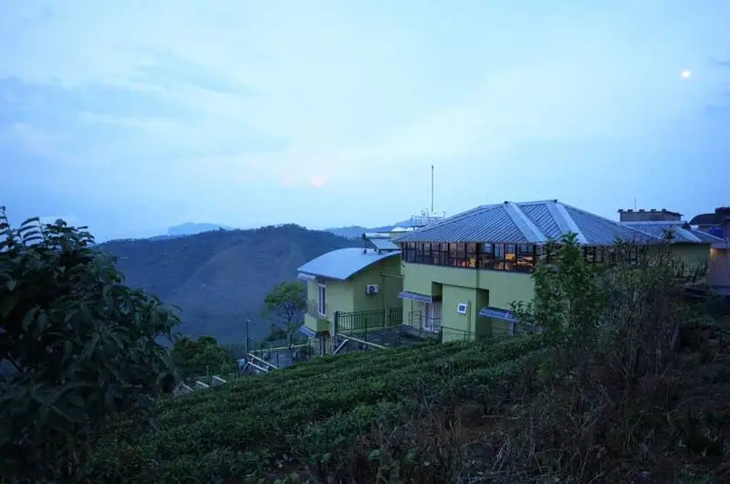 Exterior view of Vaga Mist Resort building set against blue skies and mountain landscapes