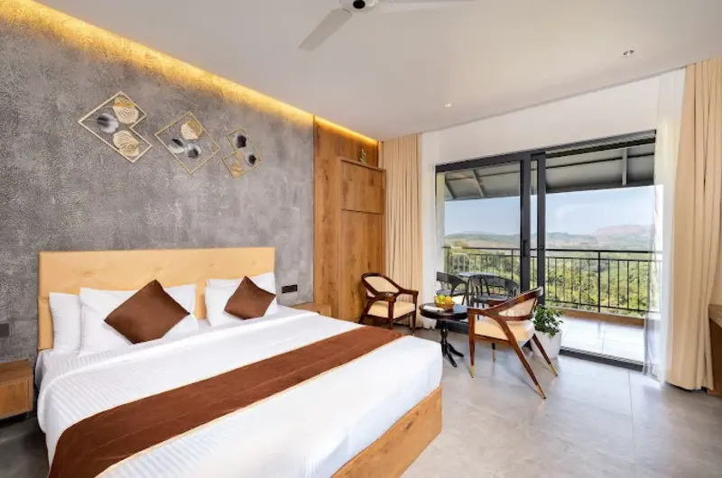 Cozy guest bedroom featuring double bed with white linens, ambient cove lighting, and glass balcony access