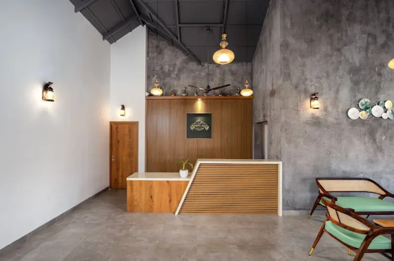 Resort reception desk featuring stone feature wall, warm lights, and reception counter at Elysian Vale Resort